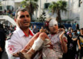 Médecin portant un enfant palestinien blessé à Gaza, Auteur Ghassan Salem